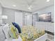 Bright main bedroom with a king bed, TV, ceiling fan, and ensuite bathroom access at 750 Bayport Way # 750, Longboat Key, FL 34228
