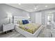 Bright main bedroom with a king bed, ceiling fan, and access to the ensuite bathroom at 750 Bayport Way # 750, Longboat Key, FL 34228