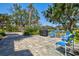 Outdoor patio with beautiful landscaping, brick pavers, and a grill for hosting barbeques at 750 Bayport Way # 750, Longboat Key, FL 34228