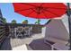 Inviting patio area featuring a dining table, chairs, and a shade umbrella for relaxing and outdoor enjoyment at 750 Bayport Way # 750, Longboat Key, FL 34228