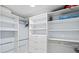 Bright walk-in closet with custom shelving, hanging rods, and ample storage space at 750 Bayport Way # 750, Longboat Key, FL 34228