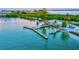 Aerial view of a waterfront restaurant with outdoor seating and docks along the serene water at 750 Bayport Way # 750, Longboat Key, FL 34228