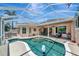 Beautiful backyard pool with screened-in lanai, patio seating, and lush landscaping providing privacy at 7624 Boltons Ct, Bradenton, FL 34201
