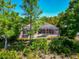 Scenic backyard with screened-in pool, spacious lanai, lush landscaping, and private setting at 7624 Boltons Ct, Bradenton, FL 34201