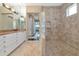 Well-appointed bathroom with a walk-in shower, dual vanity, and tile flooring at 7624 Boltons Ct, Bradenton, FL 34201