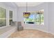 Bright breakfast nook with built in seat, view of the outdoor pool and shuttered windows at 7624 Boltons Ct, Bradenton, FL 34201