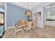 Stylish dining room featuring a modern light fixture and neutral colors at 7624 Boltons Ct, Bradenton, FL 34201