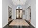 Elegant foyer with grand double doors, high ceilings, and tile flooring at 7624 Boltons Ct, Bradenton, FL 34201