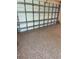 Open garage door with detailed view of internal mechanism and speckled flooring at 7624 Boltons Ct, Bradenton, FL 34201