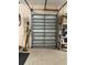 Garage with door, storage shelves, and some tools and items at 7624 Boltons Ct, Bradenton, FL 34201