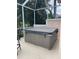 An outdoor hot tub in a screened-in lanai area, perfect for relaxation and recreation at 7624 Boltons Ct, Bradenton, FL 34201