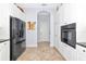 Modern kitchen with black appliances, white cabinetry, and tile flooring at 7624 Boltons Ct, Bradenton, FL 34201