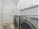 Well-equipped laundry room with modern washer and dryer, ample cabinet space, and neutral decor at 7624 Boltons Ct, Bradenton, FL 34201