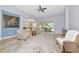 Open-concept living room with neutral colors and views of the outdoor pool at 7624 Boltons Ct, Bradenton, FL 34201