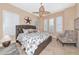 Cozy main bedroom features a plush bed, ceiling fan and shuttered windows at 7624 Boltons Ct, Bradenton, FL 34201