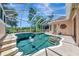 Inviting screened-in pool with beautiful water features, steps for entry, and lush green surroundings at 7624 Boltons Ct, Bradenton, FL 34201