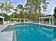 Inviting community swimming pool featuring ample deck space and shaded pergola seating areas at 7624 Boltons Ct, Bradenton, FL 34201