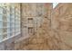 Walk-in shower featuring beautiful tilework, glass block accents, and a built-in bench at 7624 Boltons Ct, Bradenton, FL 34201
