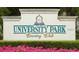 Close up of University Park Country Club signage surrounded by manicured greenery and vibrant flowers at 7624 Boltons Ct, Bradenton, FL 34201