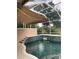 A swimming pool with awning and water features. and lush greenery at 7624 Boltons Ct, Bradenton, FL 34201