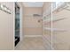 Spacious walk-in closet with built-in shelving and tile flooring offering ample storage space at 7624 Boltons Ct, Bradenton, FL 34201