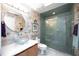 Stylish bathroom features a glass bowl sink, decorative mirror, and updated shower with glass door at 8142 Misty Oaks Blvd, Sarasota, FL 34243