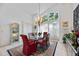 Elegant dining room featuring a chandelier, large windows, and a stylish rug at 8142 Misty Oaks Blvd, Sarasota, FL 34243