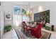 Elegant dining room featuring high ceilings, bright natural light, and charming decor at 8142 Misty Oaks Blvd, Sarasota, FL 34243