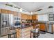 Modern kitchen featuring a glass block island, stainless steel appliances, and stylish countertops at 8142 Misty Oaks Blvd, Sarasota, FL 34243