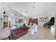 Bright and airy living room with high ceilings, tile flooring, and access to a screened lanai at 8142 Misty Oaks Blvd, Sarasota, FL 34243