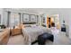 Bright main bedroom featuring neutral decor, large bed, and ensuite office space at 8142 Misty Oaks Blvd, Sarasota, FL 34243