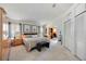Spacious bedroom featuring neutral decor, two windows with nice light, and a large closet for organized storage at 8142 Misty Oaks Blvd, Sarasota, FL 34243