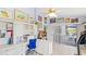 Bright office space with white built-in cabinets and a view to the screened in patio at 8142 Misty Oaks Blvd, Sarasota, FL 34243