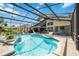 View of a screened pool and patio, with a lounge chair and outdoor dining set, for poolside relaxation and outdoor enjoyment at 8142 Misty Oaks Blvd, Sarasota, FL 34243