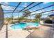Backyard pool with lounge chairs, surrounded by a screened enclosure, lush landscaping, and offering a serene outdoor space at 8142 Misty Oaks Blvd, Sarasota, FL 34243