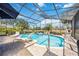 Backyard pool featuring a built-in spa, poolside lounge chairs, and lush landscaping, creating a private and relaxing retreat at 8142 Misty Oaks Blvd, Sarasota, FL 34243
