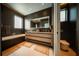 Modern bathroom with dark tile, soaking tub, and floating vanity at 816 Goodrich Ave, Sarasota, FL 34236
