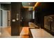 Modern bathroom featuring dark tile, a walk-in shower, and soaking tub at 816 Goodrich Ave, Sarasota, FL 34236