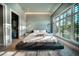 Modern bedroom with a sleek platform bed, walk-in closet, and large windows at 816 Goodrich Ave, Sarasota, FL 34236