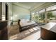 Modern bedroom featuring a large window, sleek platform bed, and stylish decor at 816 Goodrich Ave, Sarasota, FL 34236