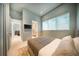 Modern bedroom with ensuite bathroom, neutral tones, and large windows at 816 Goodrich Ave, Sarasota, FL 34236