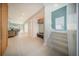 Inviting foyer leads into an open-concept living space featuring a staircase and neutral color palette at 816 Goodrich Ave, Sarasota, FL 34236