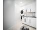 Well-organized laundry area with modern appliances and sleek white cabinetry at 816 Goodrich Ave, Sarasota, FL 34236