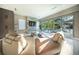 Stylish living room with large windows, a comfortable sectional sofa, and a modern entertainment center at 816 Goodrich Ave, Sarasota, FL 34236