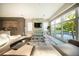 Bright living room featuring a comfortable sectional sofa, contemporary entertainment center, and large windows at 816 Goodrich Ave, Sarasota, FL 34236