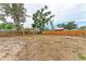 Spacious backyard featuring a wooden fence, mature trees, and a charming wooden gazebo at 1016 38Th W St, Bradenton, FL 34205