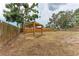 Wide view of the backyard with a wooden gazebo, highlighting the yard's size and wooden perimeter fence at 1016 38Th W St, Bradenton, FL 34205