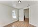 A minimalist bedroom featuring hardwood floors, crisp white walls, and natural light at 1016 38Th W St, Bradenton, FL 34205