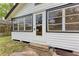 Charming home exterior features black trim, windows, and a cozy sunroom entrance, adding character to the property at 1016 38Th W St, Bradenton, FL 34205
