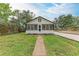 Attractive home showcasing lush lawn, gravel drive, walkway, and classic black and white color scheme, presenting curb appeal at 1016 38Th W St, Bradenton, FL 34205